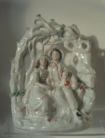 A Staffordshire arbour group of a couple  with their dog