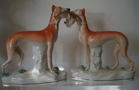 A pair of Early Staffordshire Standing Whippets with Hares