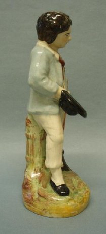 A Staffordshire Figure Of A Boy With A Broom