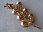Goldtone and faux pearl brooch.