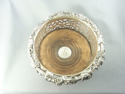 A SILVER PLATED BOTTLE OR DECANTER COASTER