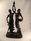 Resin figures of two partially dressed maidens