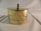 An oval shaped brass tobacco box