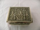 A heavily embossed brass box